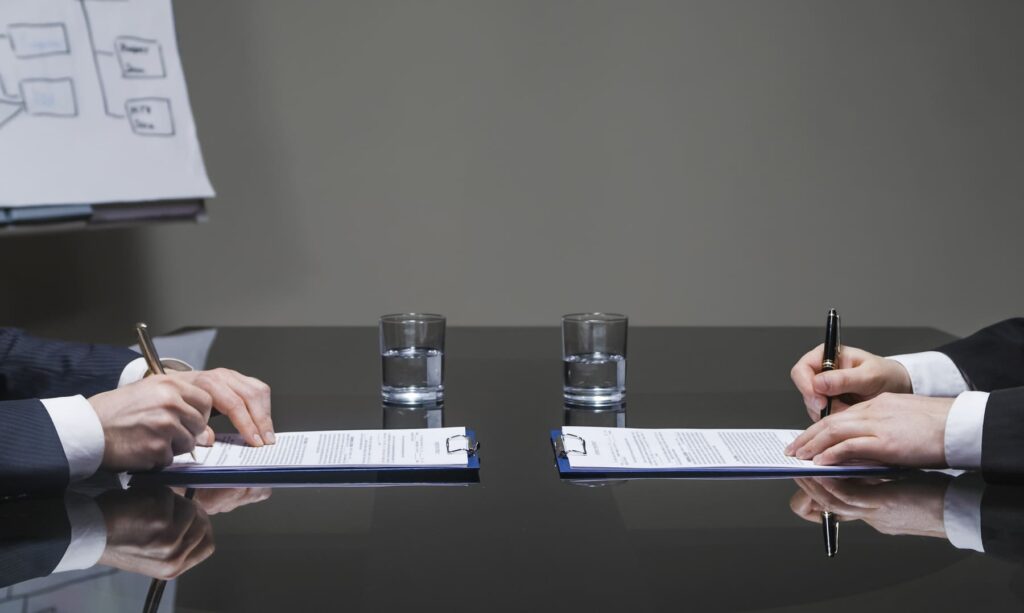 Businessmen signing contracts